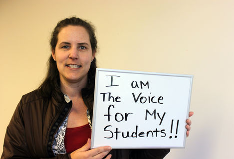 Educator with sign - I am the voice for my students